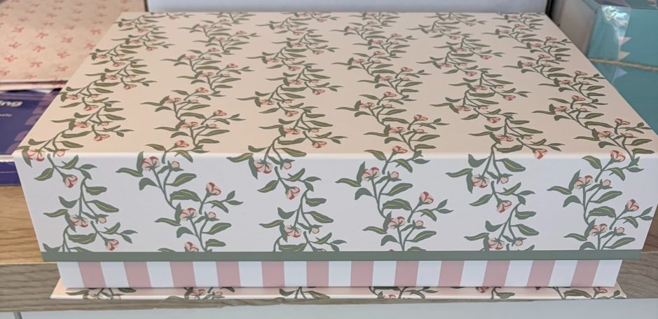 The magnetic keepsake giftbox purchased for the luxury gift set. Floral-patterned box with a pink and green design, sitting on a flat surface.