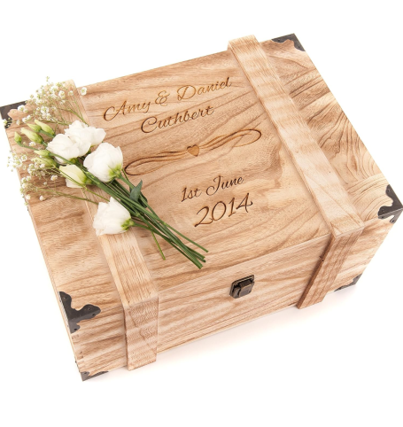 Personalised wooden wedding day keepsake gift box for the bride and groom. Wooden box with engraved text and white flowers arranged on top.